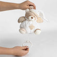Load image into Gallery viewer, Pink Musical Lullaby Bear, 15cm plush toy being manually activated by pulling the string to play soft lullabies. Includes a velcro strap for easy attachment.