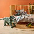 Load image into Gallery viewer, Dinosaur Night Light on the floor of a child's room.