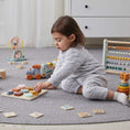 Load image into Gallery viewer, Wooden Shape Puzzle Toy with various shapes for children. Made from natural wood and non-toxic paint, suitable for kids 12 months and older. A child happily plays with the puzzle, learning shapes and coordination.