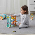 Load image into Gallery viewer, Child playing with the car ramp racer in a calm environment surrounded by toys