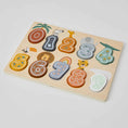 Load image into Gallery viewer, Wooden number puzzle with colorful pieces scattered on a surface. The puzzle is designed to teach counting and coordination skills for young children