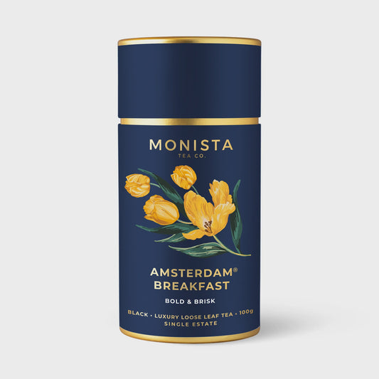 Amsterdam Breakfast Tea: A rich, amber-colored loose leaf tea packaged in a sleek, eco-friendly container by Monista Tea Co.