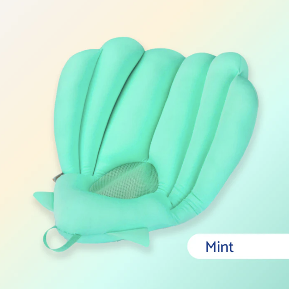 Mint Green Bebe Bleue Sink Bather Shell providing a safe, comfortable bath seat for newborns and infants in a kitchen sink.