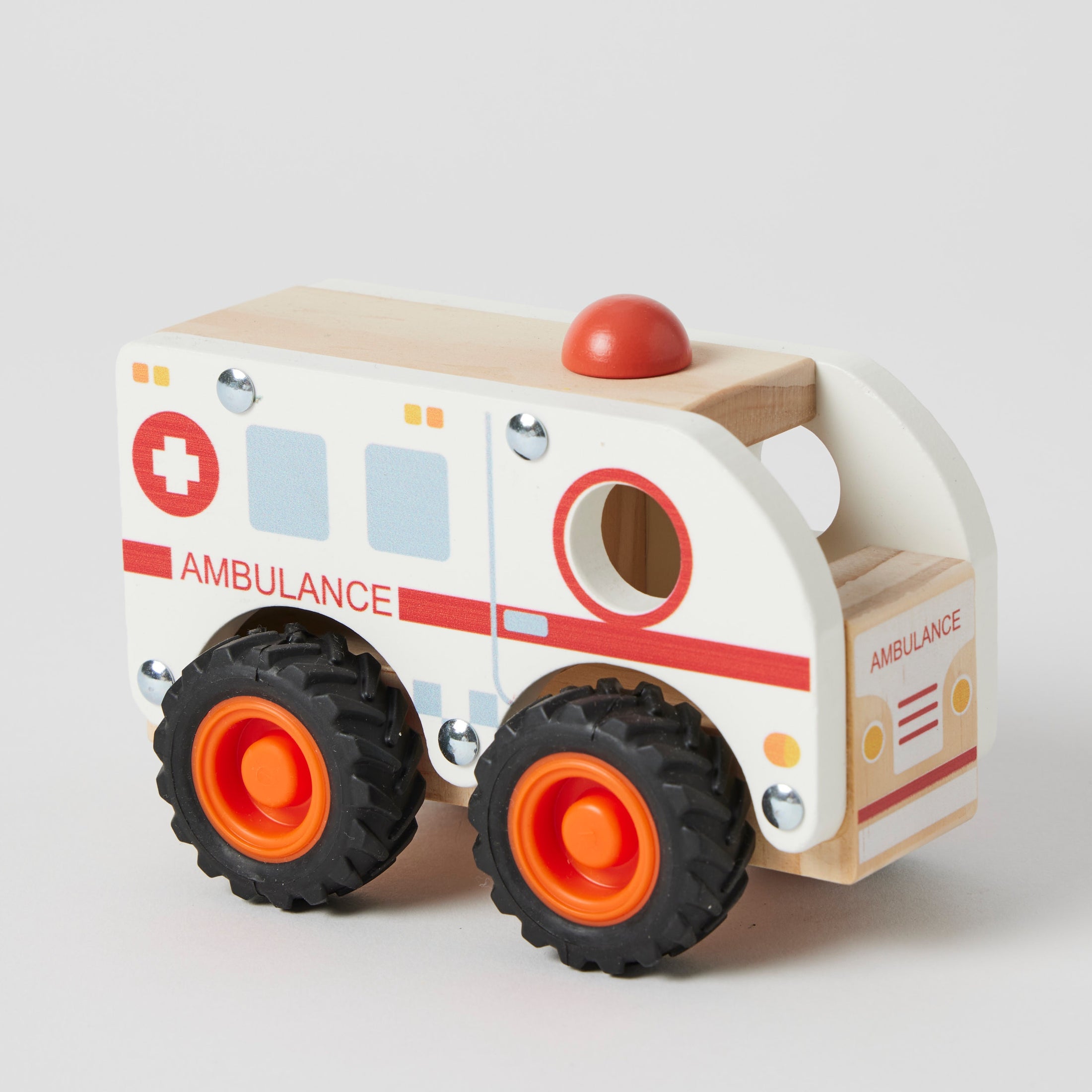 A wooden ambulance toy with white, red, and blue colors, featuring rubber wheels and a durable design, perfect for imaginative play for children 18 months and older.