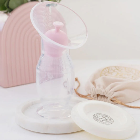 Breast Milk Saver with suction base and lid, designed to catch milk during letdown, shown in its compact, travel-friendly design.