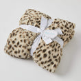 Load image into Gallery viewer, Jiggle and Giggle by Pilbeam presents: Wrapped in elegance, Jiggle and Giggle by Pilbeam unveils the Animal Print Faux Fur Baby Blanket, adorned with a chic ribbon and swing tag.
