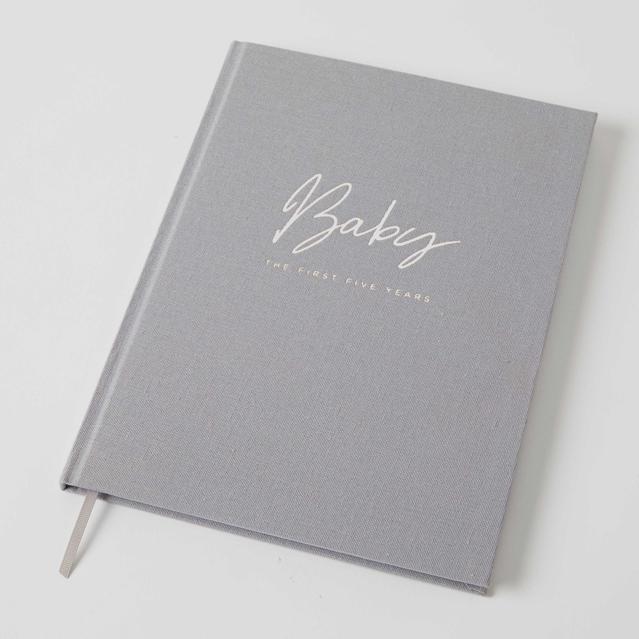 Beautiful grey fabric hard cover Baby Journal. It's written on the cover "Baby the first five years"