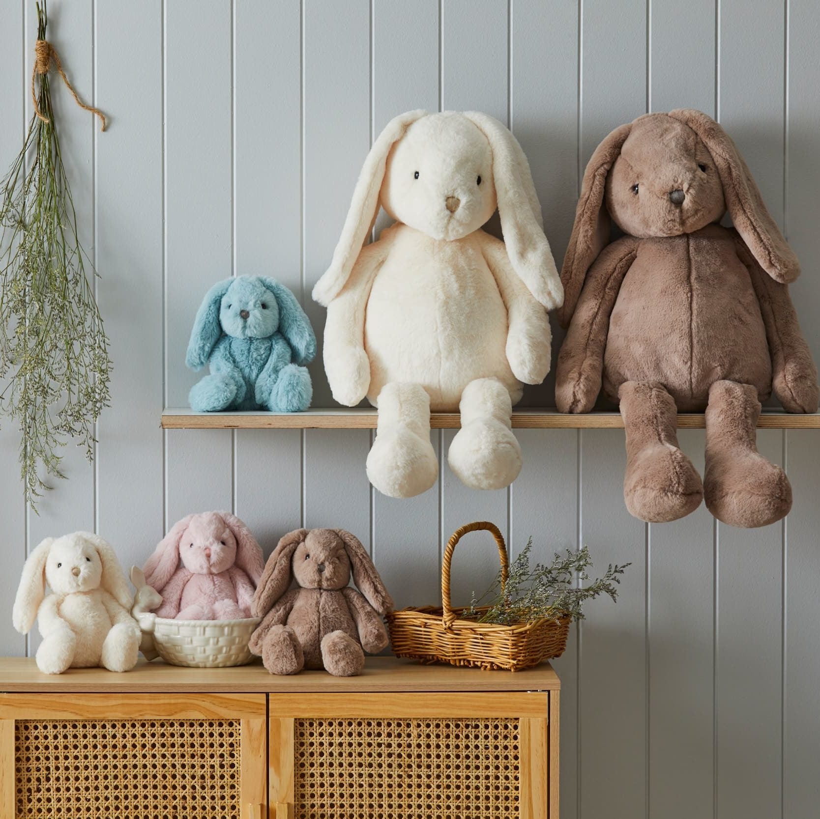 Aqua Bunny Small Success: Sitting on a shelf surrounded by other plush toys in a cozy bedroom scene, ready to bring joy to any child.