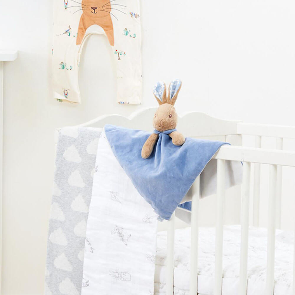 Peter Rabbit Comfort Blanket on crib bed, showcasing its softness and baby-safe features.