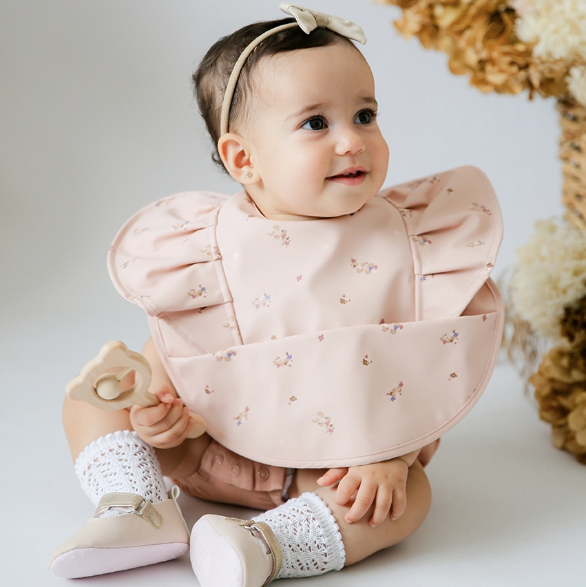 Posy Snuggle Bib - Waterproof, soft, and stylish with a handy in-built pocket for catching food spills.