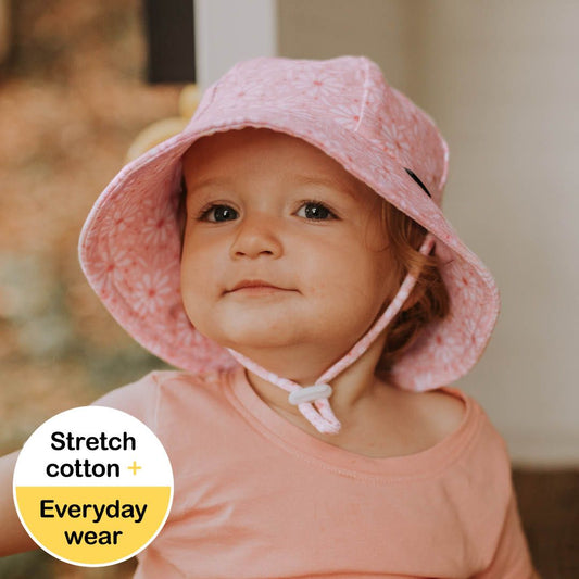 Toddler wearing the 'Daisy' print Bedhead Toddler Bucket Hat, showcasing the soft, flexible brim and stylish pink polka-dot design.