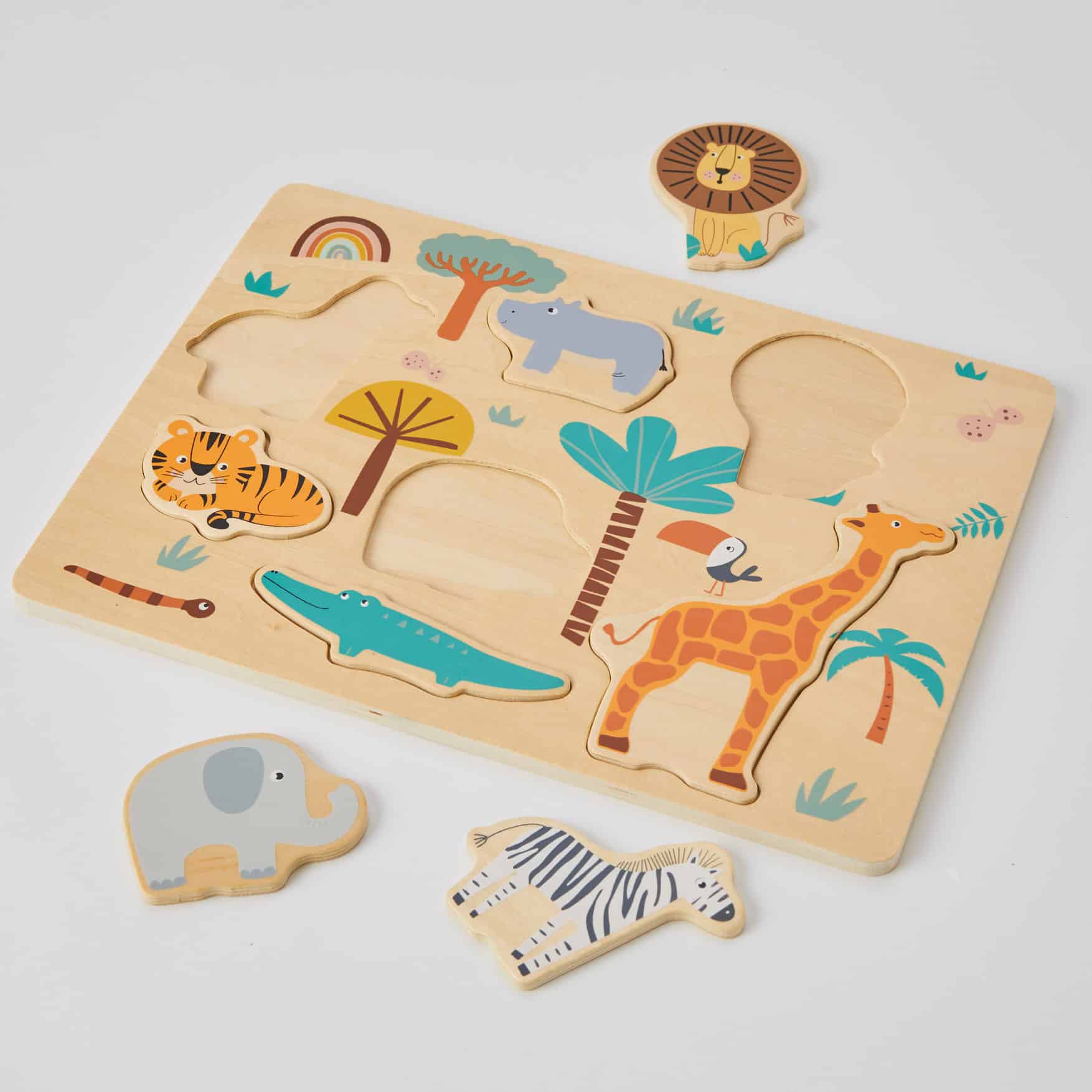 Introducing Animal Puzzle by Zookabee: a captivating wooden toy adorned with intricately cut animal shapes like giraffes, elephants, crocodiles, tigers, hippos, and zebras. With removable pieces, children develop fine motor skills as they fit each figure into its corresponding slot.