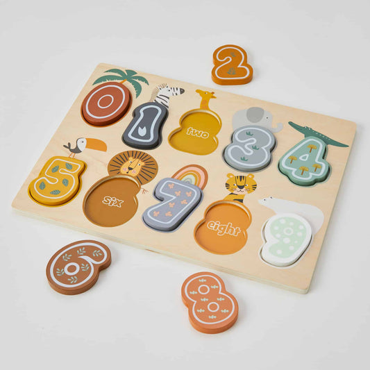 The number puzzle is displayed with pieces scattered around and being fitted into the wooden board, highlighting how children can coordinate their movements to match numbers and learn through play.