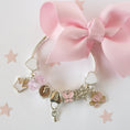 Load image into Gallery viewer, Cinderella Charm Bracelet by Lauren Hinkley in a gift box, featuring silver-plated charms including a glittering star, pink butterfly, and heart key charm
