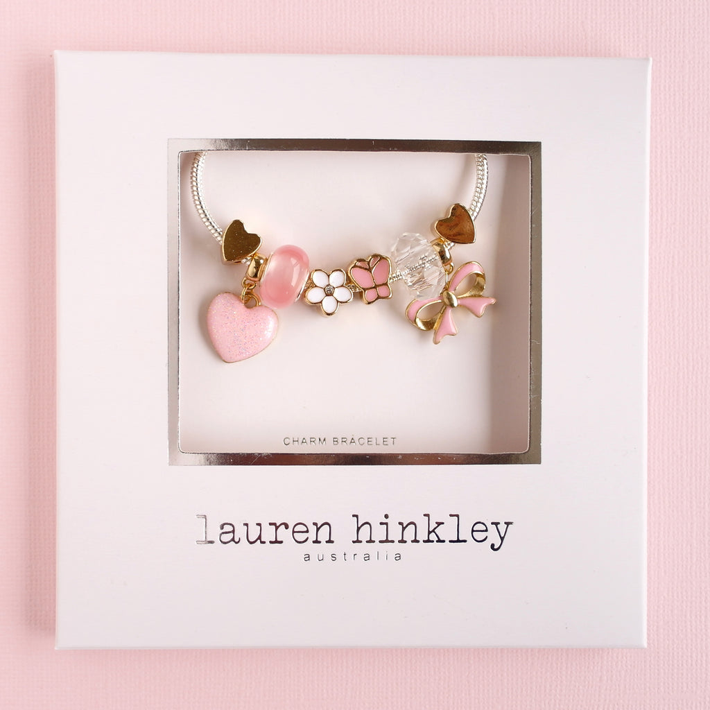 Lauren Hinkley Fantasia Charm Bracelet displayed in a gift box with silver-plated, enamel, resin, and glass charms on a 15cm chain