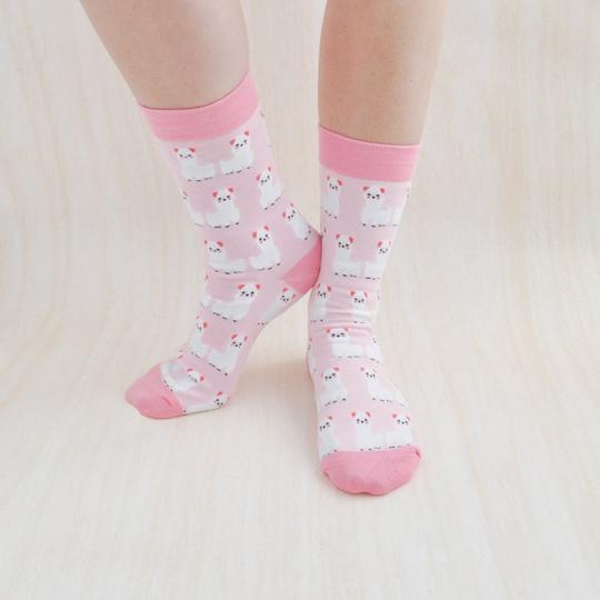 Comfortable pink and white Llama socks featuring a cute llama design. These soft and cozy socks are perfect for adding a touch of fun to any outfit with their playful llama pattern.